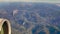 Passenger View out of passenger airplane window during flight, while crossing the alps southbound - parts of airplane engine are v