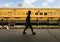 A passenger walks past a train