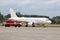 Passenger white plane and a fire truck at the airport. Place for text. Runway. Travel. Taxiing. Takeoff and landing. Arrival and