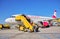 Passengers boarding an Austrian Airlines airplane at Vienna International Airport, on a sunny day with a perfect clear blue sky