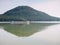 Passengers boat pass the bay and continue in lake tour