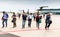 Passengers disembarking a small charter propeller engine airplane at local airport