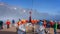 Passengers gathered on the front observation deck in red and yellow jackets enjoying the arctic scenery on Hurtigrutens MS Fridtj