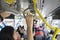 Passengers hold handle on the Transjakarta bus