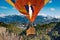 Passengers into hot air balloon basket and flames flying from Mainalo to Helmos mountains.Arcadia, Greece