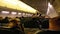 Passengers inside the cabin of passenger aircraft sitting on the chairs during the flight at night