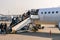 Passengers loading in plane in airport