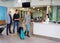 Passengers With Luggage Waiting At Airport Reception