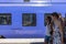 Passengers passing blue train Ystad Sweden