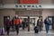 Passengers passing by the Skywalk of of the train station of Union Station with the historic logo of Canadian National Railways