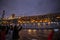 Passengers photographing illuminated cruise ship before boarding