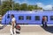 Passengers on platform passing blue train Ystad