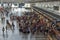 Passengers queue to check in at the airport