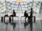 Passengers seen in silhouette waiting in Frankfurt Airport