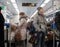 Passengers standing and sitting at train. Moscow Central Circle.