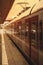 Passengers train in station at golden hour