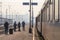 Passengers waiting to board a train on the platform of Belgrade main train station during a sunny afternoon