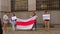 Passer took photo protest Belarusians wall building hands white-red-white flag