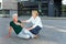 Passerby helping sick senior woman