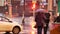 Passers-by under umbrellas are walking along sidewalk in heavy rain.