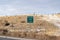 Passing Lane road sign at the side of a highway against grassy and snowy slope