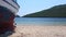 Passing between two wooden boats on the sand beach in bay. Aerial drone