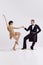 Passion. Elegant couple of dancers in vintage evening dress and suit dancing retro ballroom dance. Love and music