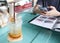 Passion fruit juice with soda on the table and background of a man using mobile smart phone in restaurant