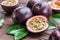 Passion fruits and its cross section with pulpy juice filled with seeds. Wooden background