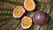 Passion fruits on rotating background. Top view. Exotic fruit, tropical palm branch. Vegan and raw food concept.