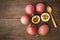 Passion fruits and slice with wooden spoon on wooden background.