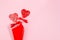 Passion valentines day background - couple sweet red lollipops hearts as bouquet on pastel pink color, copy space.