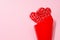 Passion valentines day background - couple sweet red lollipops hearts as bouquet on pastel pink color, copy space.