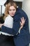 Passionate couple hugging and having a love affair in the office. Workplace flirt or romance. Business man and woman are