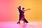 Passionate dancers. Artistic, talented young man and woman in motion in beautiful stage costumes dancing ballroom