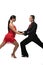 Passionate, elegant dancers looking at each other and holding hands while performing tango