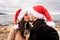 Passionate kiss of lover couple on sea rocks in winter sea Christmas and New Year vacation - Young beautiful girlfriend and