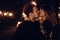 Passionate lovers sexually kissing in evening city street. styli