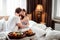 Passionate male and female embrace each other, look with love, spend their honeymoon in luxury hotel, enjoy delicious