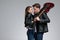 Passionate man embracing his girlfriend and holding a guitar