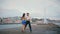 Passionate pair performing latin american dance on embanking. Couple dancing