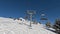 Passo del Tonale, Italy. Chairlift with skiers is moving to the top of the ski runs