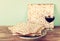 Passover background. wine and matzoh (jewish passover bread) over wooden background.