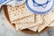 Passover celebration concept. Matzah, red kosher and walnut. Traditional ritual Jewish bread matzah, kippah and tallit