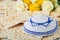 Passover celebration concept. Matzah, red kosher, white and yellow roses and walnut. Traditional ritual Jewish bread matzah,