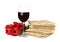 Passover matzos, glass of wine and flowers on background. Pesach celebration