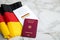 Passport and  constitution basic law book of Germany with flag on marble background