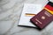 Passport and  constitution basic law book of Germany with flag on marble background