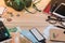 Passport, euro coin, euro banknote, headphones, passport, touristic map and traveler supplies on office wooden desk table.