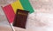 Passport and a Guinea flag on a wooden background